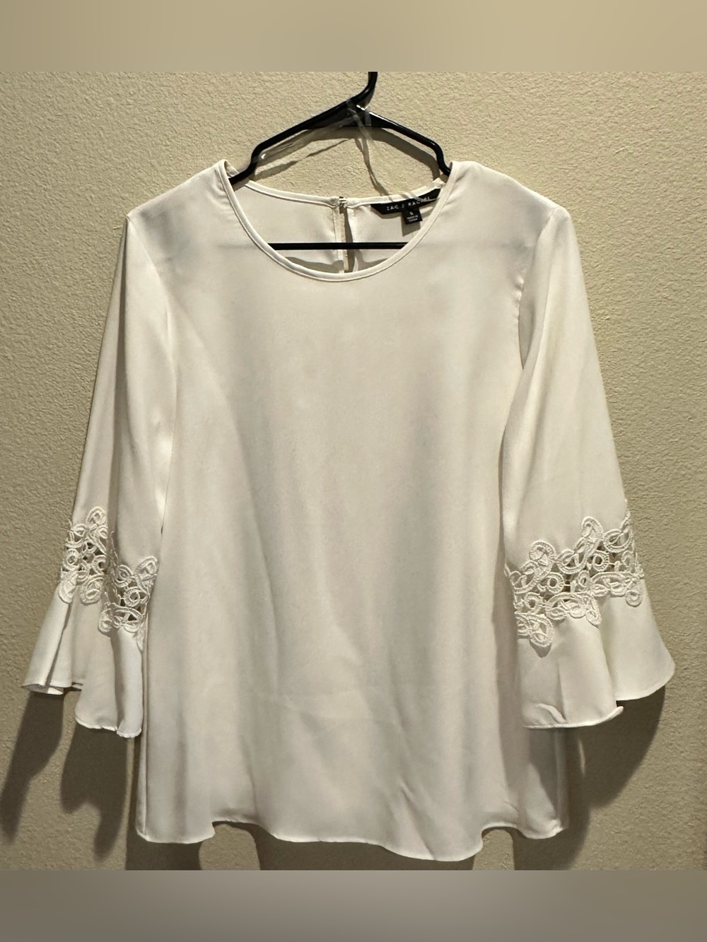 Creamy White tunic blouse w/ lace detail, and ruffle sleeves. Women’s Small.